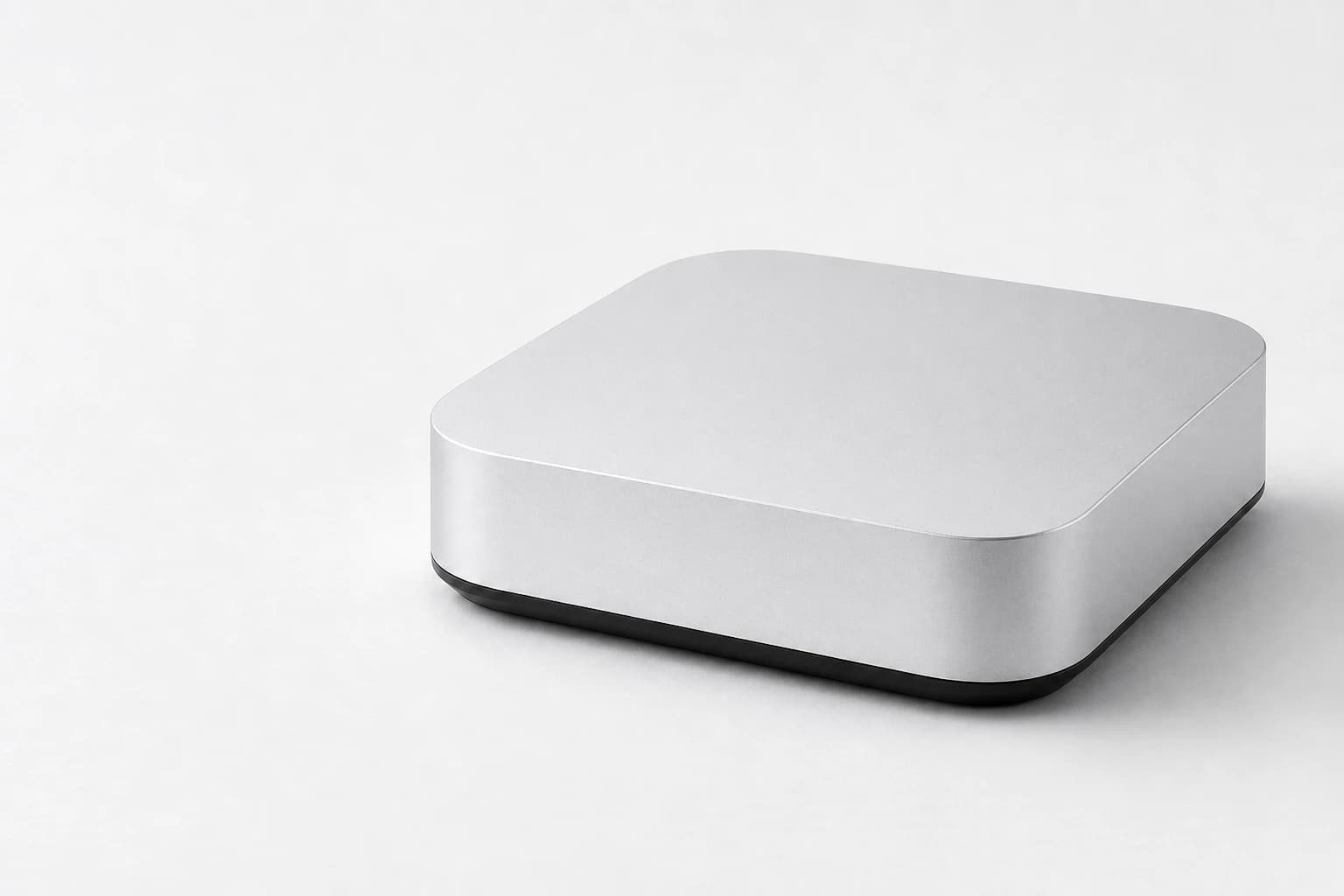 A compact silver computer representing the Attyn AI Box deployment concept.
